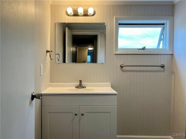 152 W Cayuga St, Oswego, NY 13126 - bathroom featuring vanity, ornamental molding, and wood walls