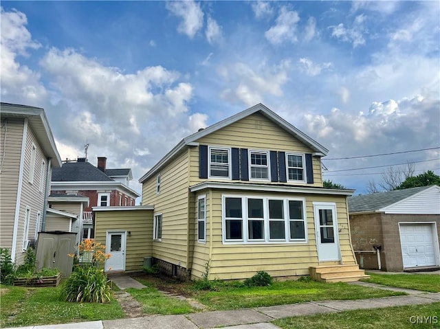 152 W Cayuga St, Oswego, NY 13126 - traditional-style home with entry steps, an outbuilding, and a detached garage