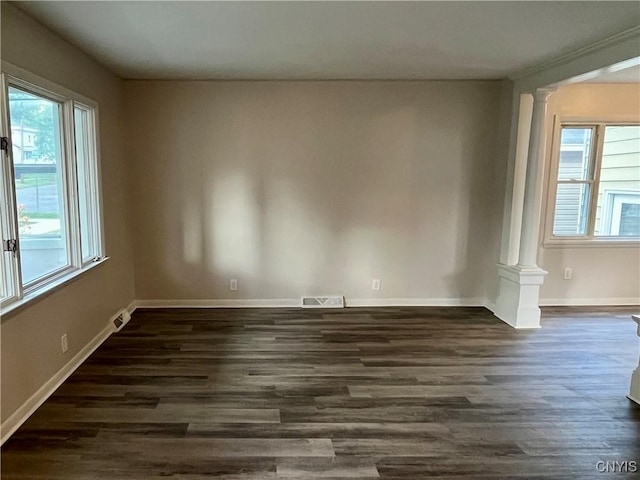 152 W Cayuga St, Oswego, NY 13126 - empty room with decorative columns, healthy amount of natural light, and dark wood-style floors