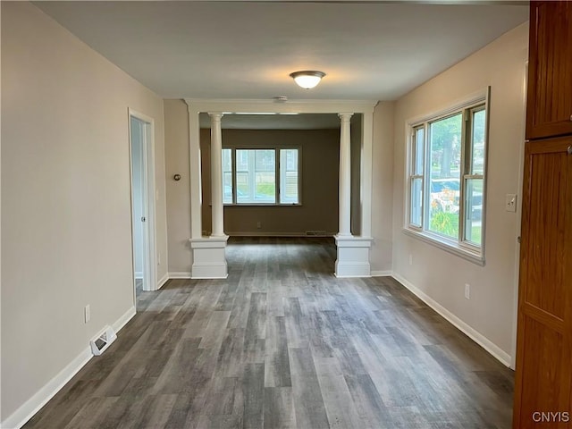 152 W Cayuga St, Oswego, NY 13126 - unfurnished room featuring decorative columns, healthy amount of natural light, and dark wood finished floors