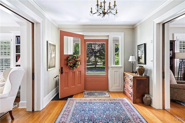 49 Academy St, Skaneateles, NY 13152 - foyer with light wood-type flooring, a chandelier, and ornamental molding