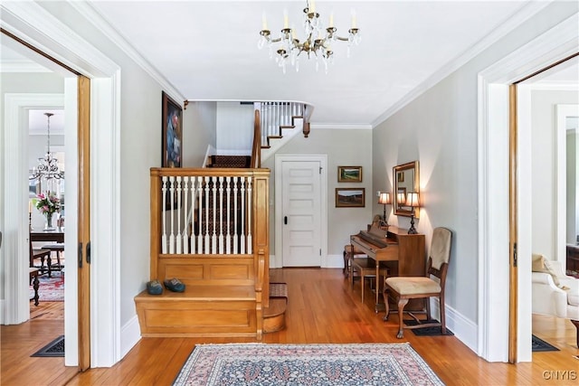 49 Academy St, Skaneateles, NY 13152 - foyer entrance with a chandelier, stairs, wood finished floors, and crown molding