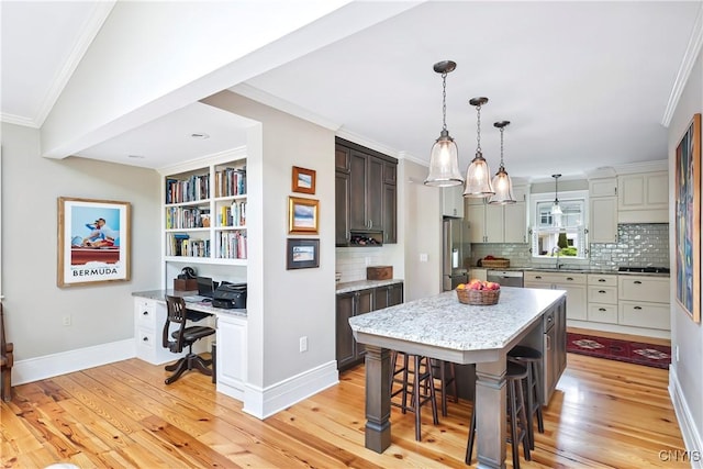 49 Academy St, Skaneateles, NY 13152 - kitchen with stainless steel appliances, light wood-style flooring, crown molding, and decorative backsplash