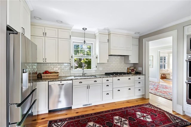 49 Academy St, Skaneateles, NY 13152 - kitchen with stainless steel appliances, white cabinets, dark stone counters, decorative backsplash, and crown molding