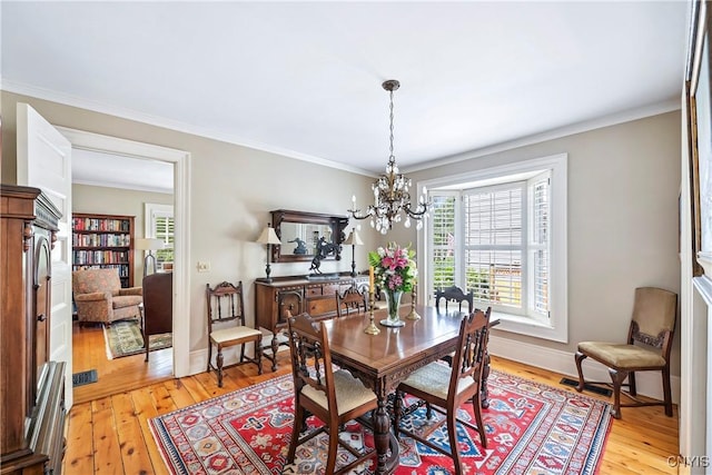 49 Academy St, Skaneateles, NY 13152 - dining space featuring a chandelier, light wood finished floors, and crown molding