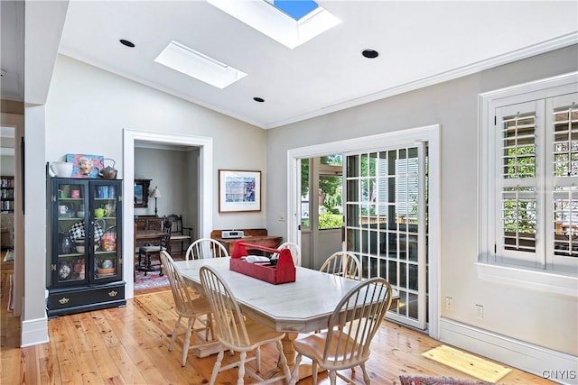 49 Academy St, Skaneateles, NY 13152 - dining room featuring a skylight, light wood-style flooring, lofted ceiling, ornamental molding, and recessed lighting