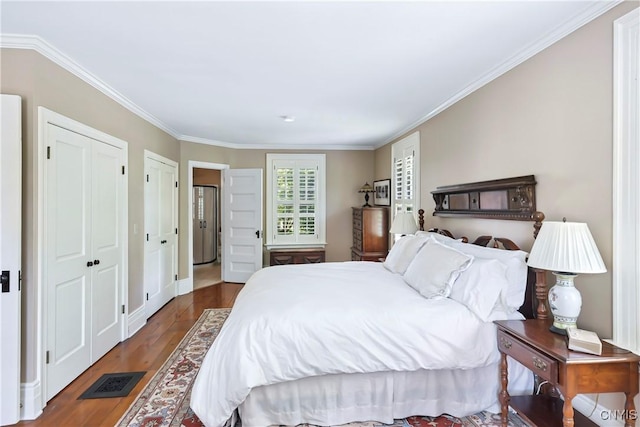 49 Academy St, Skaneateles, NY 13152 - bedroom featuring two closets, wood finished floors, and ornamental molding