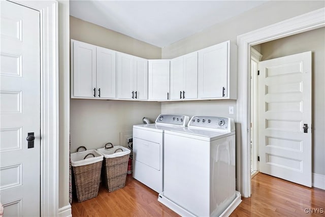 49 Academy St, Skaneateles, NY 13152 - laundry area featuring cabinet space, light wood finished floors, and independent washer and dryer