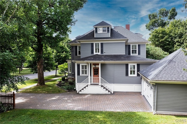 49 Academy St, Skaneateles, NY 13152 - american foursquare style home with a chimney, a front yard, roof with shingles, and a patio