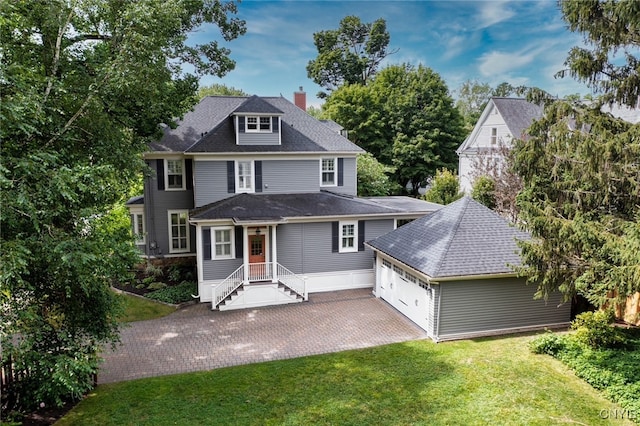49 Academy St, Skaneateles, NY 13152 - traditional style home featuring a garage, a front yard, driveway, a chimney, and roof with shingles
