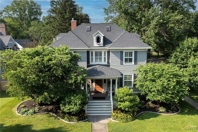 49 Academy St, Skaneateles, NY 13152 - view of front of home featuring a front lawn, a chimney, and a shingled roof