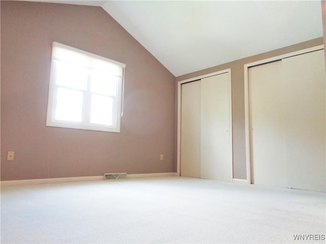 4315 Twilight Ln, Hamburg, NY 14075 - unfurnished bedroom featuring two closets, vaulted ceiling, and carpet
