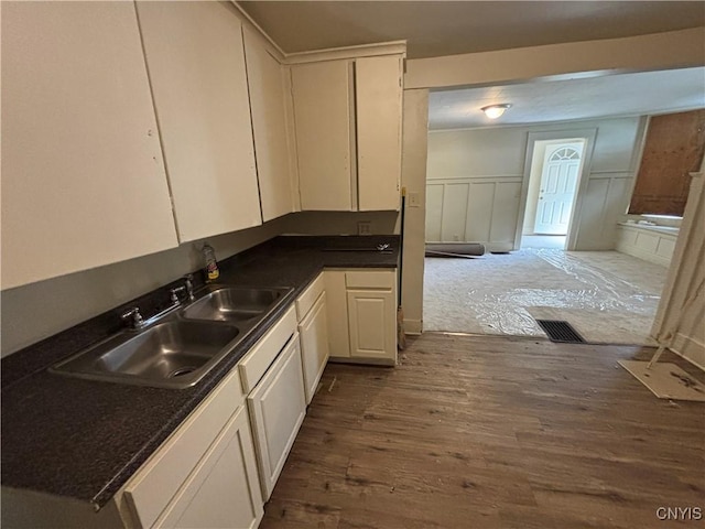 1011 Carbon St Unit 2, Syracuse, NY 13208 - kitchen with dark wood finished floors, dark countertops, and white cabinetry