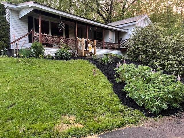 1571 State Highway 7, Afton, NY 13730 - view of front of home with covered porch and a front lawn