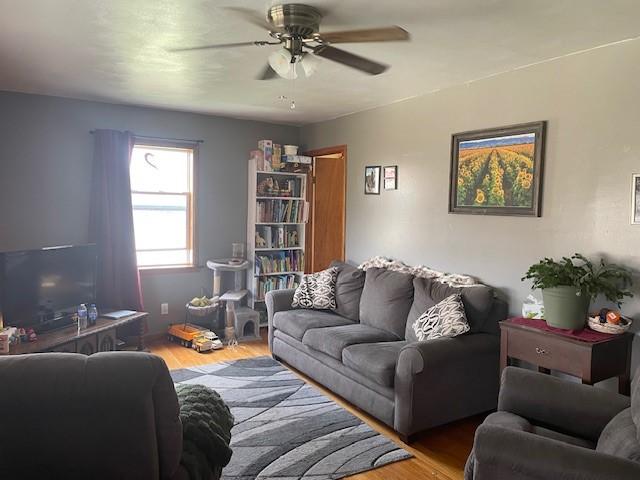 1571 State Highway 7, Afton, NY 13730 - living room with wood finished floors and ceiling fan