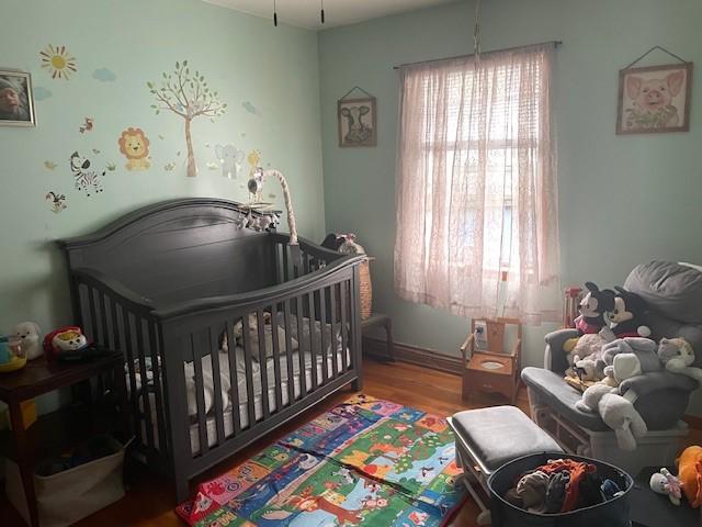 1571 State Highway 7, Afton, NY 13730 - bedroom with wood finished floors and a nursery area