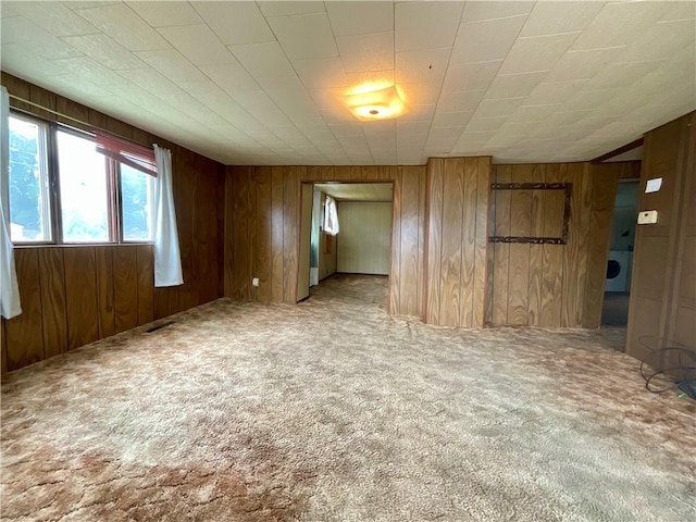 27 Chestnut Ave, North Dansville, NY 14437 - carpeted spare room featuring washer / clothes dryer and wooden walls