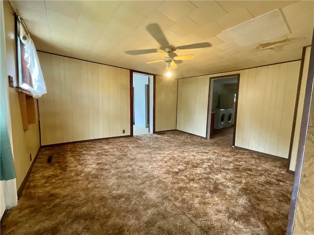 27 Chestnut Ave, North Dansville, NY 14437 - unfurnished bedroom featuring washing machine and clothes dryer, carpet floors, wooden walls, and a ceiling fan