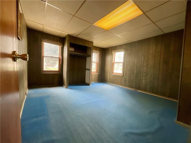 27 Chestnut Ave, North Dansville, NY 14437 - unfurnished bedroom with a drop ceiling, carpet, wood walls, and a closet