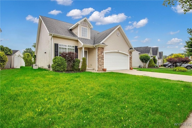 25 Caspian Ct, Amherst, NY 14228 - view of front of house featuring a front yard, a garage, concrete driveway, a shingled roof, and stone siding