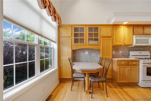 25 Caspian Ct, Amherst, NY 14228 - kitchen featuring white appliances, light countertops, backsplash, glass insert cabinets, and light wood-style floors