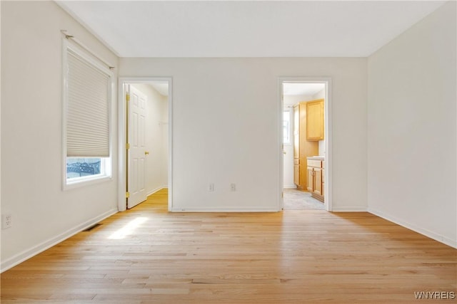 25 Caspian Ct, Amherst, NY 14228 - unfurnished bedroom featuring light wood-type flooring, a spacious closet, and connected bathroom