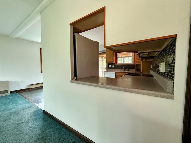 5 Riverside Ave, Oneonta, NY 13820 - kitchen featuring baseboard heating, white dishwasher, tasteful backsplash, carpet flooring, and custom exhaust hood