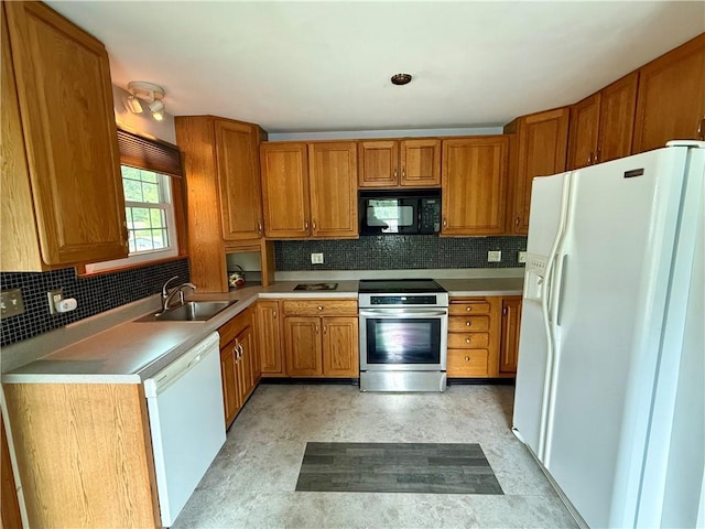 5 Riverside Ave, Oneonta, NY 13820 - kitchen featuring white appliances, brown cabinets, tasteful backsplash, and light countertops
