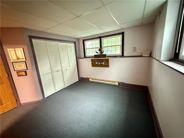 5 Riverside Ave, Oneonta, NY 13820 - unfurnished bedroom featuring a baseboard heating unit, a drop ceiling, a closet, and dark colored carpet