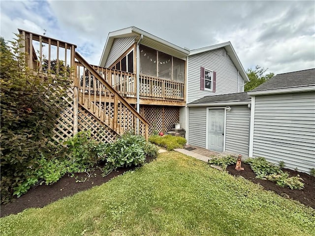 5 Riverside Ave, Oneonta, NY 13820 - rear view of property featuring a sunroom, a lawn, and stairs