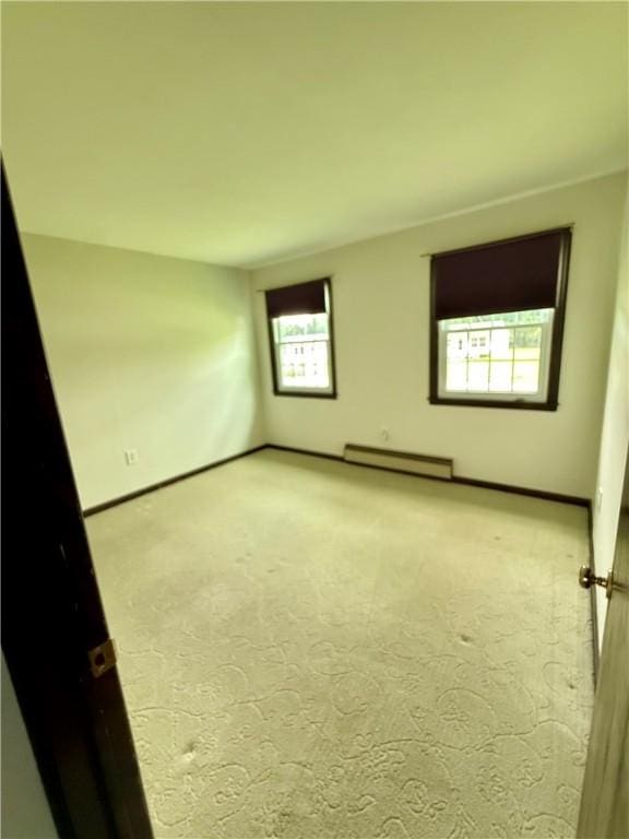 5 Riverside Ave, Oneonta, NY 13820 - spare room with a baseboard radiator and carpet flooring