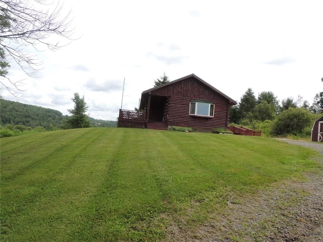 751 County Rd 17, Bainbridge, NY 13733 - back of property with driveway, a lawn, log exterior, and a storage shed
