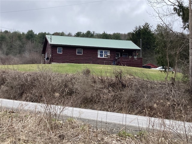 751 County Rd 17, Bainbridge, NY 13733 - log home featuring a metal roof, a deck, log exterior, and a wooded view