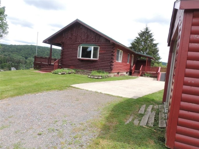 751 County Rd 17, Bainbridge, NY 13733 - view of side of home with a lawn and log siding