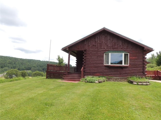 751 County Rd 17, Bainbridge, NY 13733 - view of side of property with log siding and a lawn