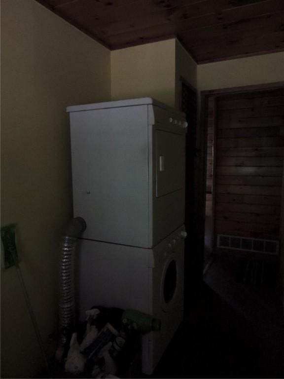 751 County Rd 17, Bainbridge, NY 13733 - laundry room featuring stacked washer / dryer and wood ceiling