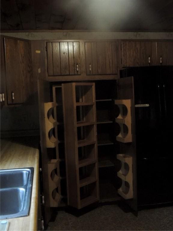 751 County Rd 17, Bainbridge, NY 13733 - kitchen with black fridge and brown cabinets