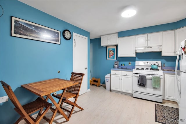 3410 Bullis Rd, Elma, NY 14059 - kitchen featuring white range with gas cooktop, under cabinet range hood, white cabinetry, and light wood-style flooring