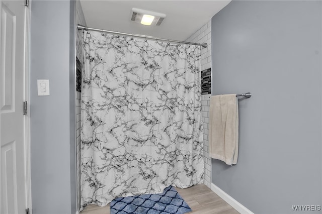 3410 Bullis Rd, Elma, NY 14059 - bathroom featuring wood finished floors and a shower with curtain