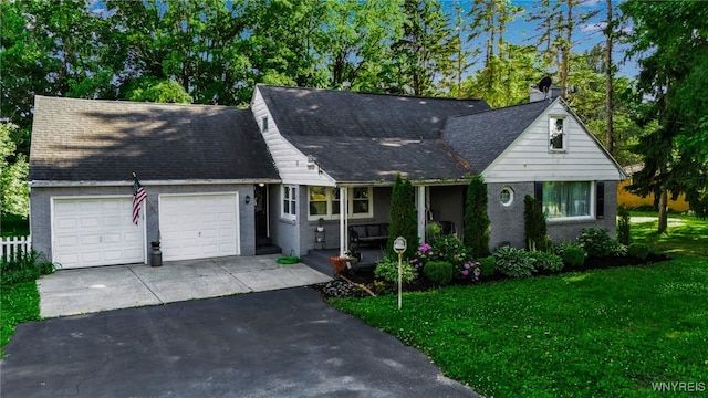 3410 Bullis Rd, Elma, NY 14059 - view of front facade featuring a garage, asphalt driveway, brick siding, and a front yard
