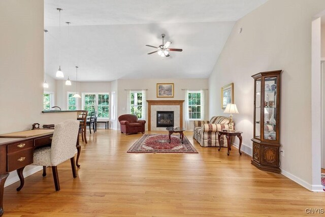 8449 Newbury Pl, Clay, NY 13041 - living area with light wood-style flooring, plenty of natural light, a ceiling fan, and high vaulted ceiling