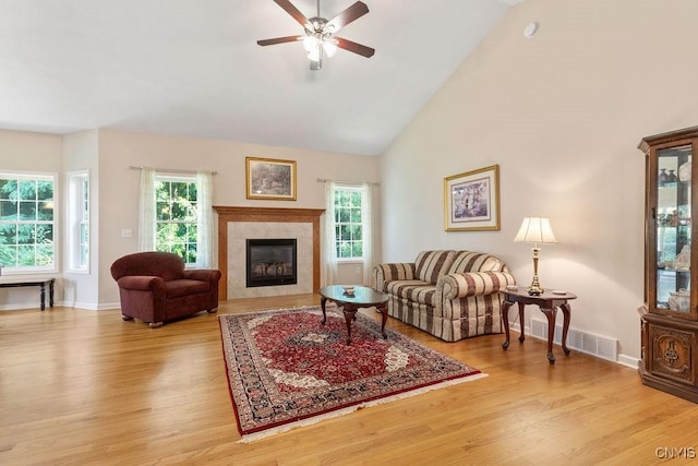 8449 Newbury Pl, Clay, NY 13041 - living area with wood finished floors, healthy amount of natural light, ceiling fan, a fireplace, and high vaulted ceiling