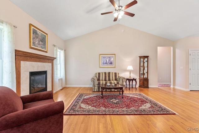 8449 Newbury Pl, Clay, NY 13041 - living room featuring ceiling fan, wood finished floors, lofted ceiling, and a tile fireplace
