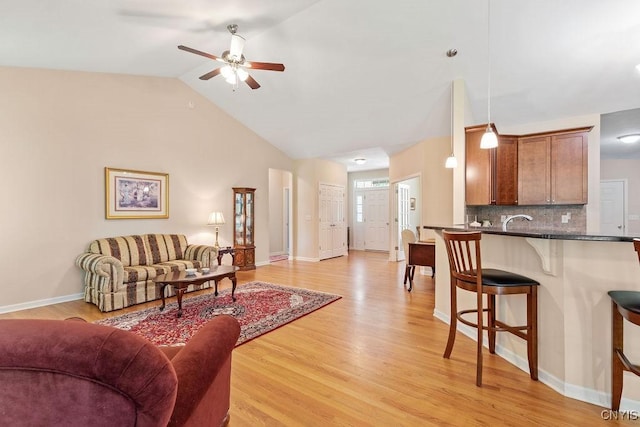 8449 Newbury Pl, Clay, NY 13041 - living room with ceiling fan, vaulted ceiling, and light wood-style flooring