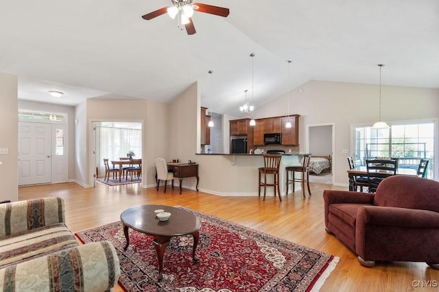 8449 Newbury Pl, Clay, NY 13041 - living room with light wood-type flooring, ceiling fan, and high vaulted ceiling