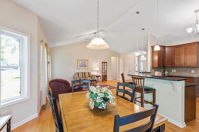 8449 Newbury Pl, Clay, NY 13041 - dining room with healthy amount of natural light, vaulted ceiling, and light wood finished floors