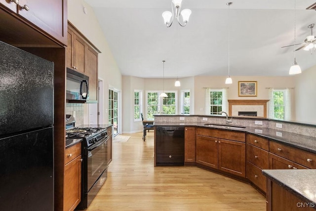 8449 Newbury Pl, Clay, NY 13041 - kitchen with black appliances, light wood-style flooring, decorative light fixtures, a fireplace, and ceiling fan