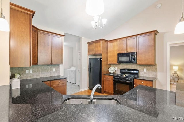 8449 Newbury Pl, Clay, NY 13041 - kitchen with black appliances, separate washer and dryer, dark stone counters, backsplash, and brown cabinetry