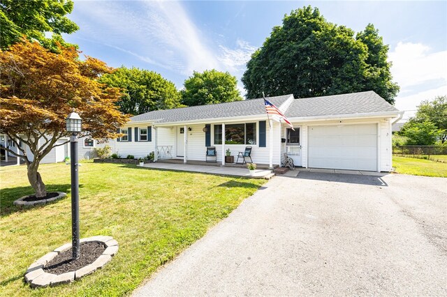 118 Fern Castle Dr, Irondequoit, NY 14622 - ranch-style home featuring an attached garage, driveway, a porch, and a front lawn
