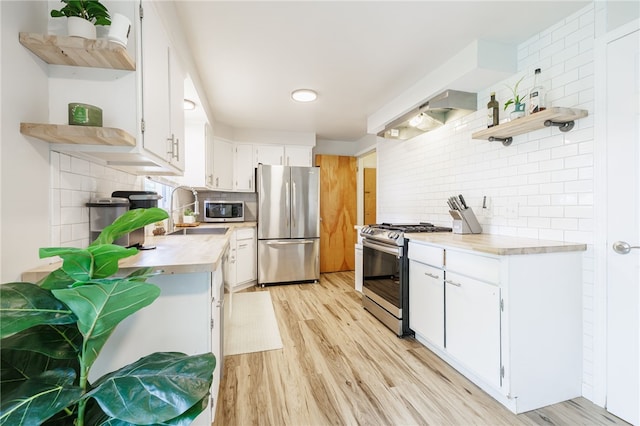 118 Fern Castle Dr, Irondequoit, NY 14622 - kitchen featuring open shelves, appliances with stainless steel finishes, light countertops, decorative backsplash, and white cabinetry